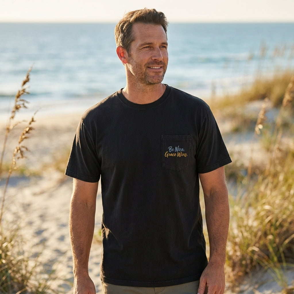 Man wearing the Everyday Pocket Tee in Black near the beach