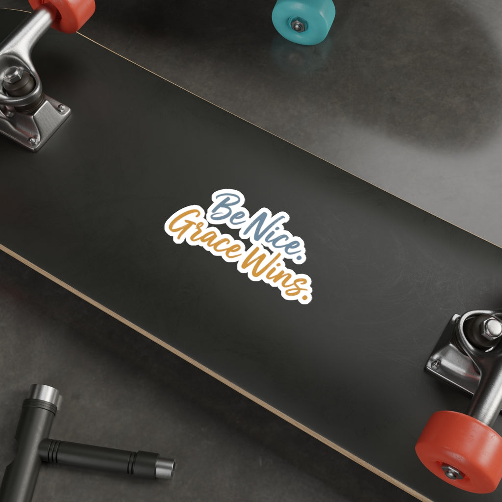Be Nice Grace Wins Die-Cut Sticker on a skateboard deck