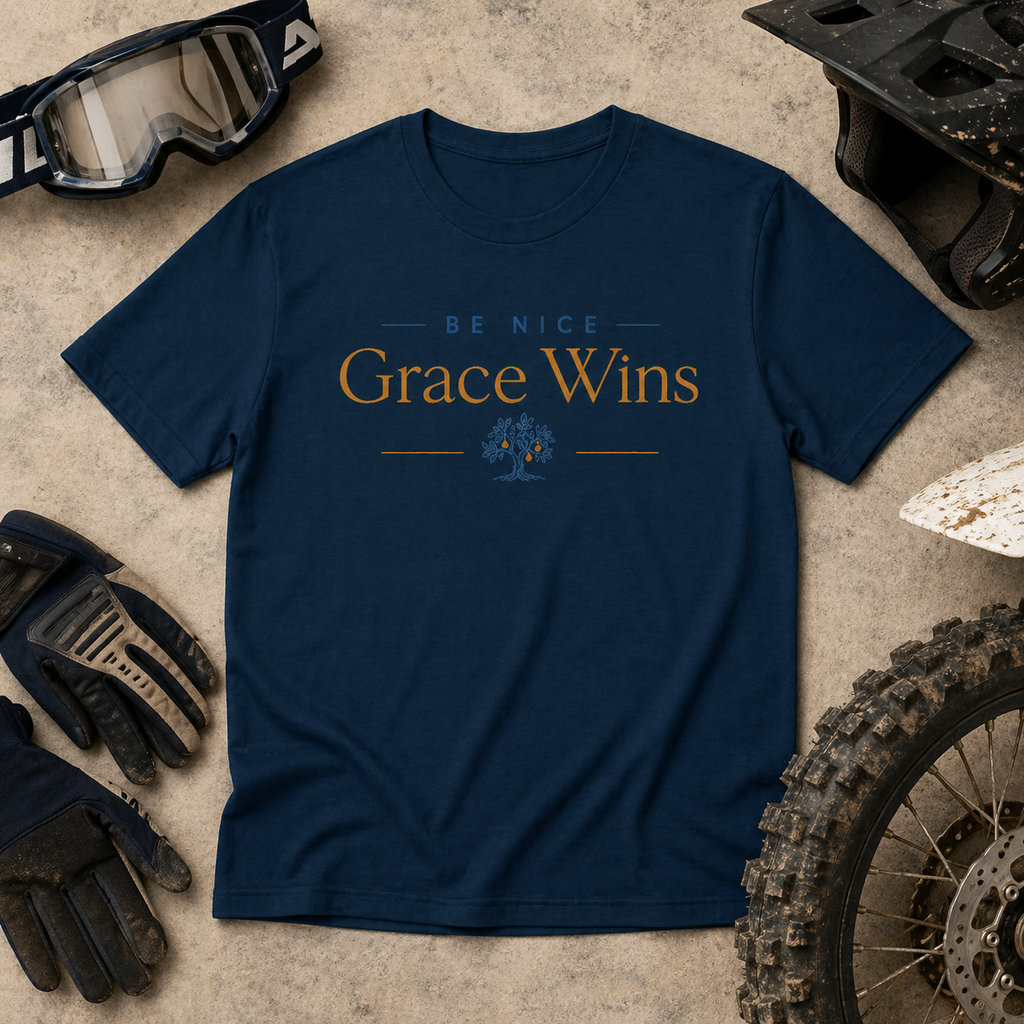 Be Nice Performance Tee in Navy laid flat with motocross gear
