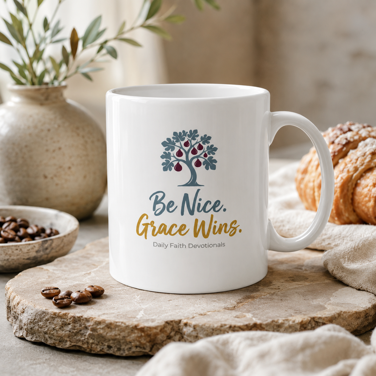 Be Nice Grace Wins Ceramic Mug on a kitchen counter with coffee beans and pastry
