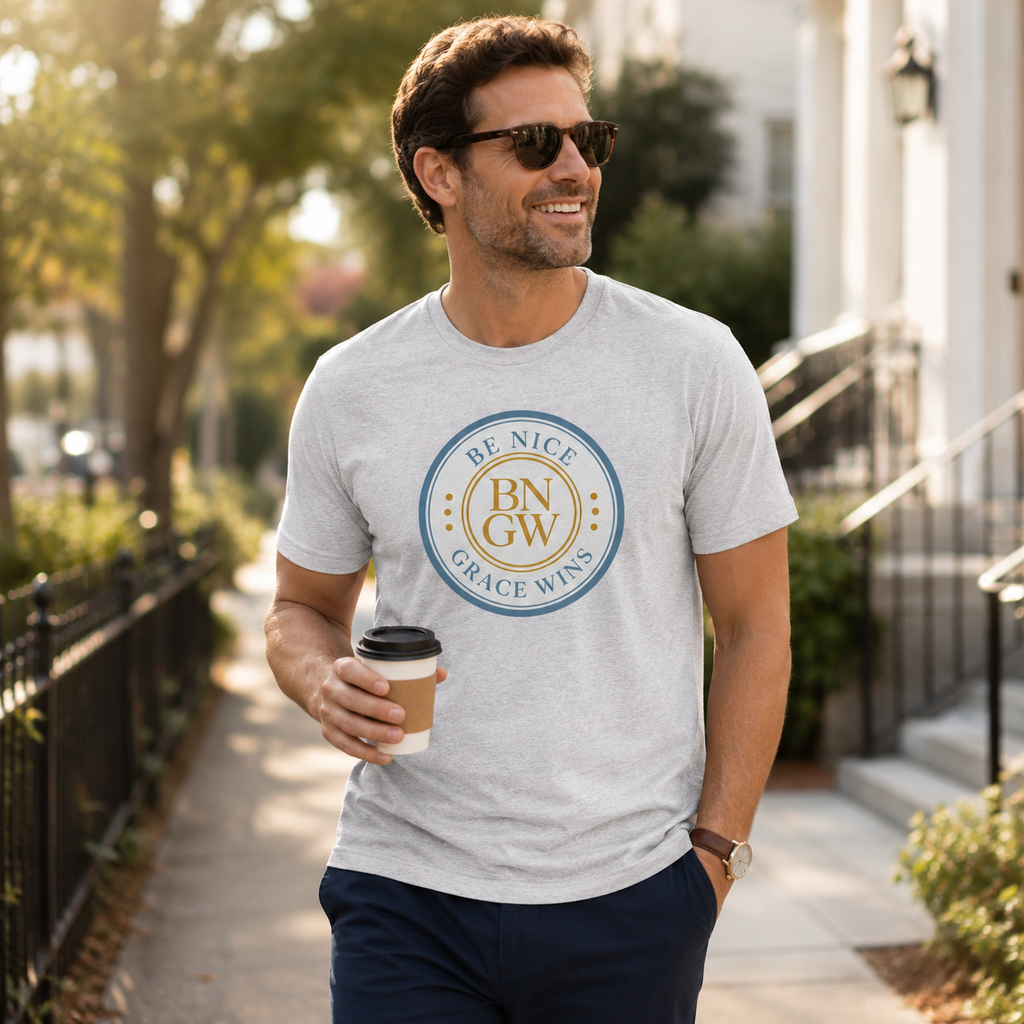 Man wearing the Tri-Blend Tee in Athletic Heather holding coffee outdoors