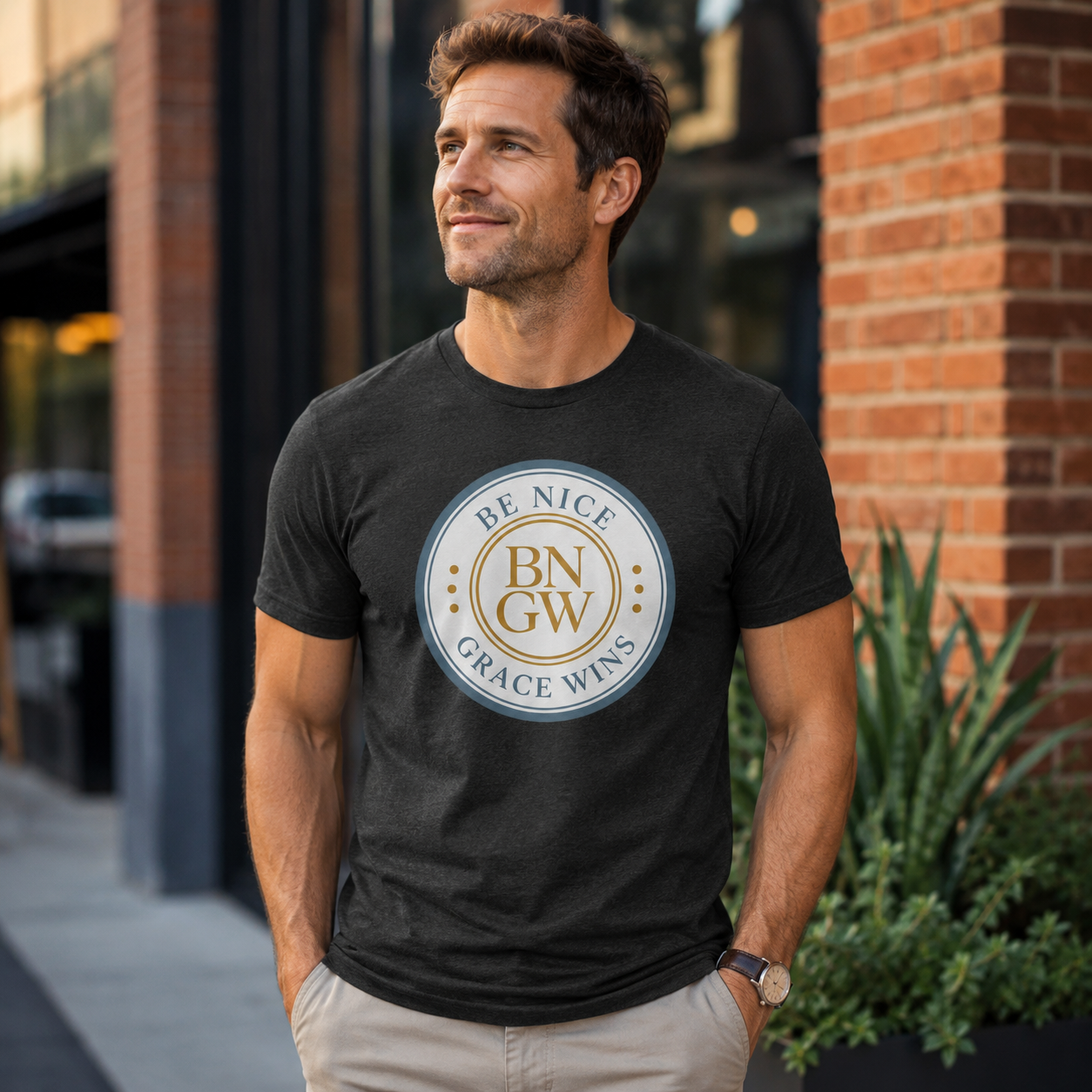 Man wearing the Tri-Blend Tee in Heather Black outside a cafe